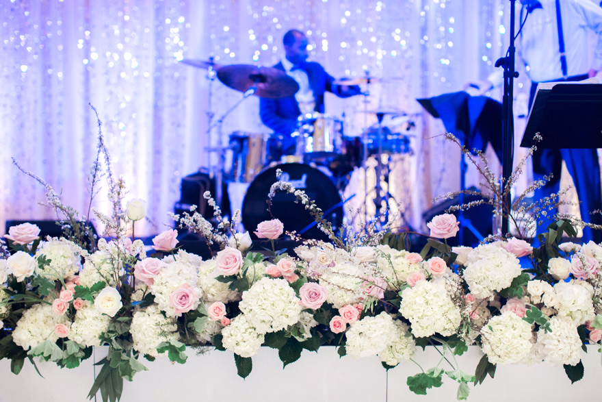 floral stage decorations at a wedding reception