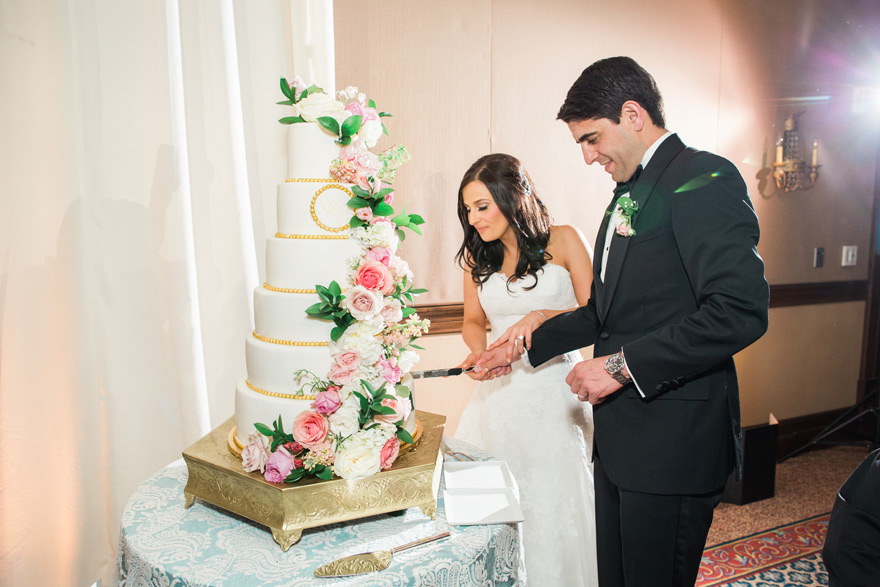 elegant six-tier wedding cake with pink flowers