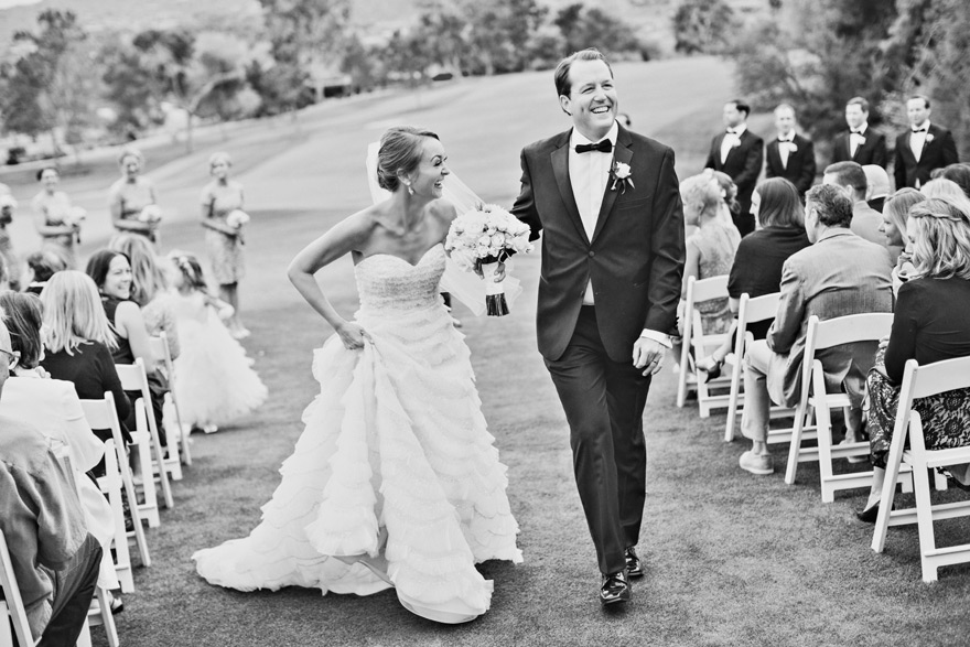 Bride & groom laughing as they walk back down the aisle