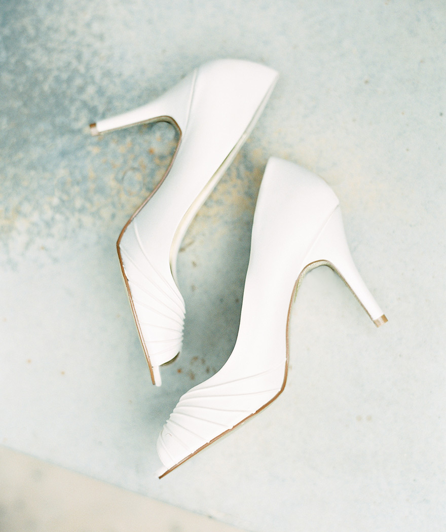 Stylish white wedding shoes. Peep-toe heels 