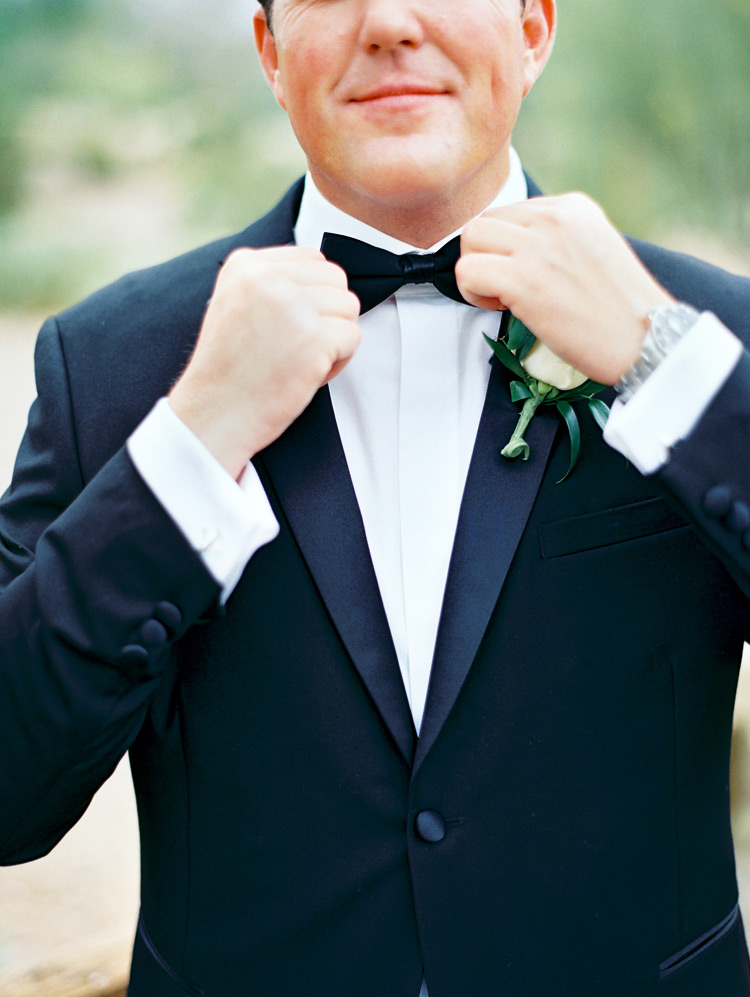Groom's final touches! Black tux with bow tie. 