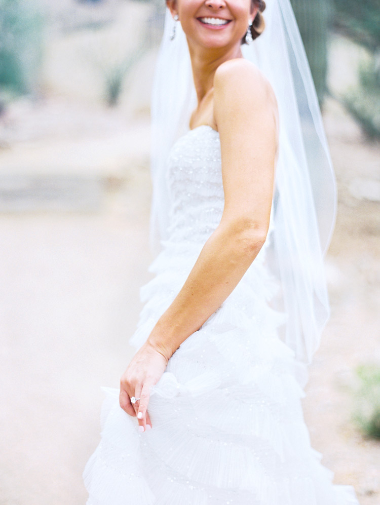 Happy bride in her sparkling, ruffled gown. Wedding style