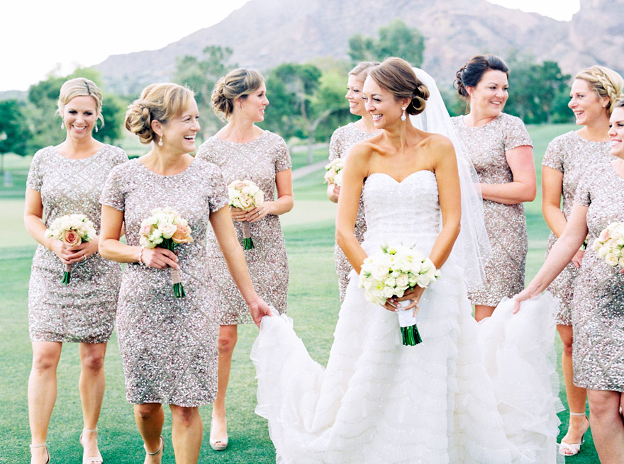 Laughing bride with her bridesmaids. Outdoor wedding, sequined dresses.