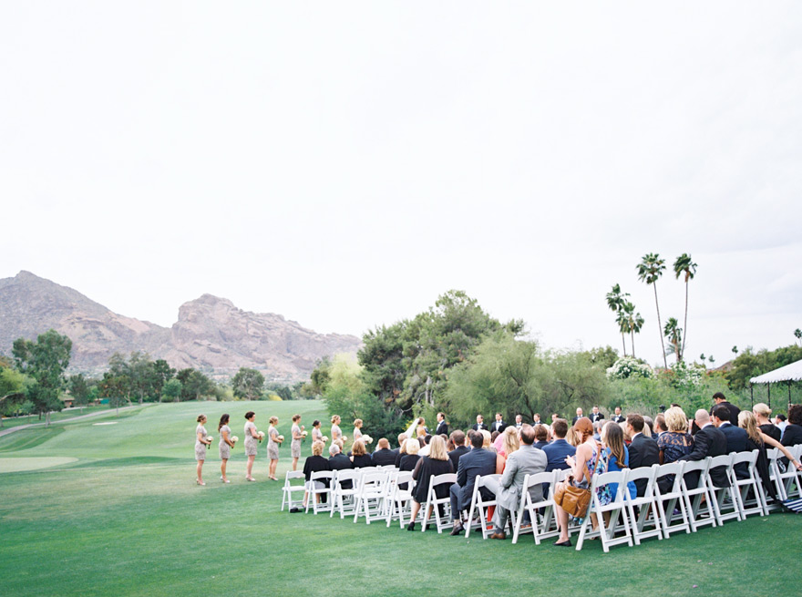Outdoor wedding ceremony with Arizona mountains in the background.