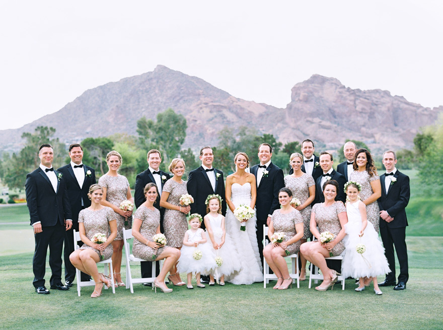 Elegant bridal party in sequined dresses and black tuxes