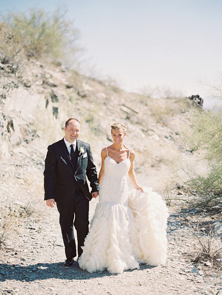 beaded wedding gown from Enaura and a black three-piece suit