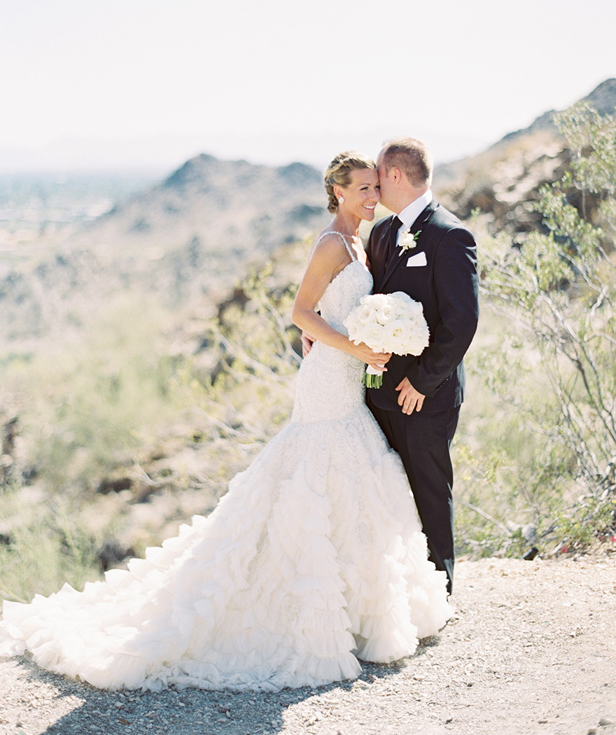 beaded wedding gown from Enaura and a black three-piece suit