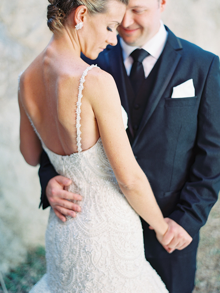 beaded wedding gown from Enaura and a black three-piece suit