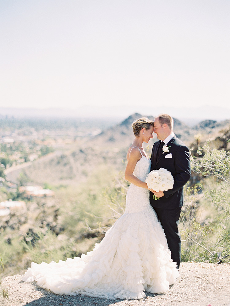 beaded wedding gown from Enaura and a black three-piece suit