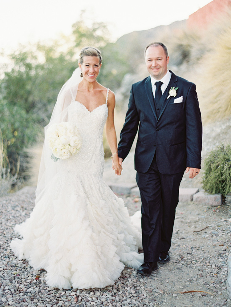 beaded wedding gown from Enaura and a black three-piece suit