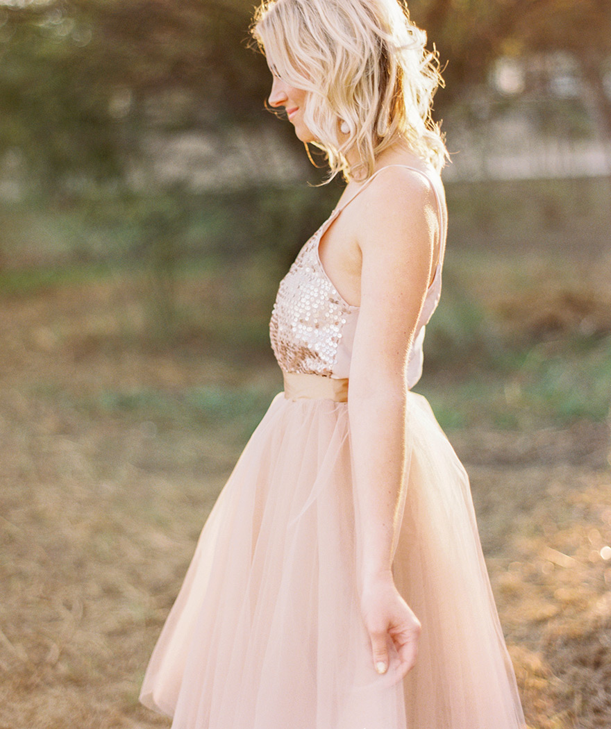 Simple side shot of natural girl smiling in blush dress. 