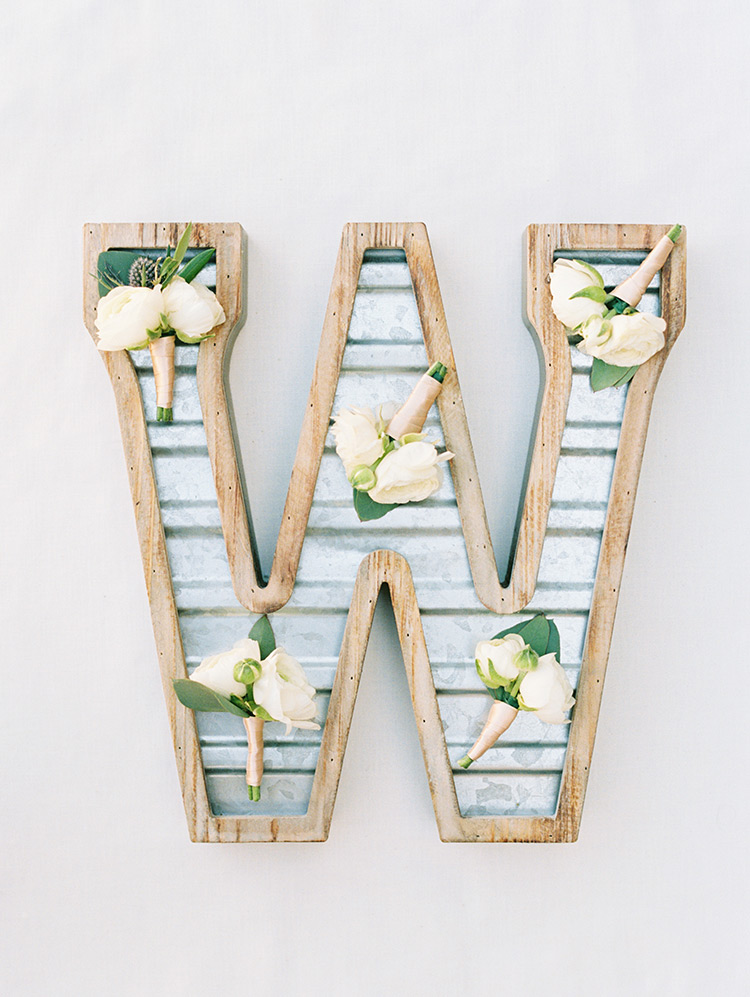 fun metal letter decor displays groomsmen's boutonnieres