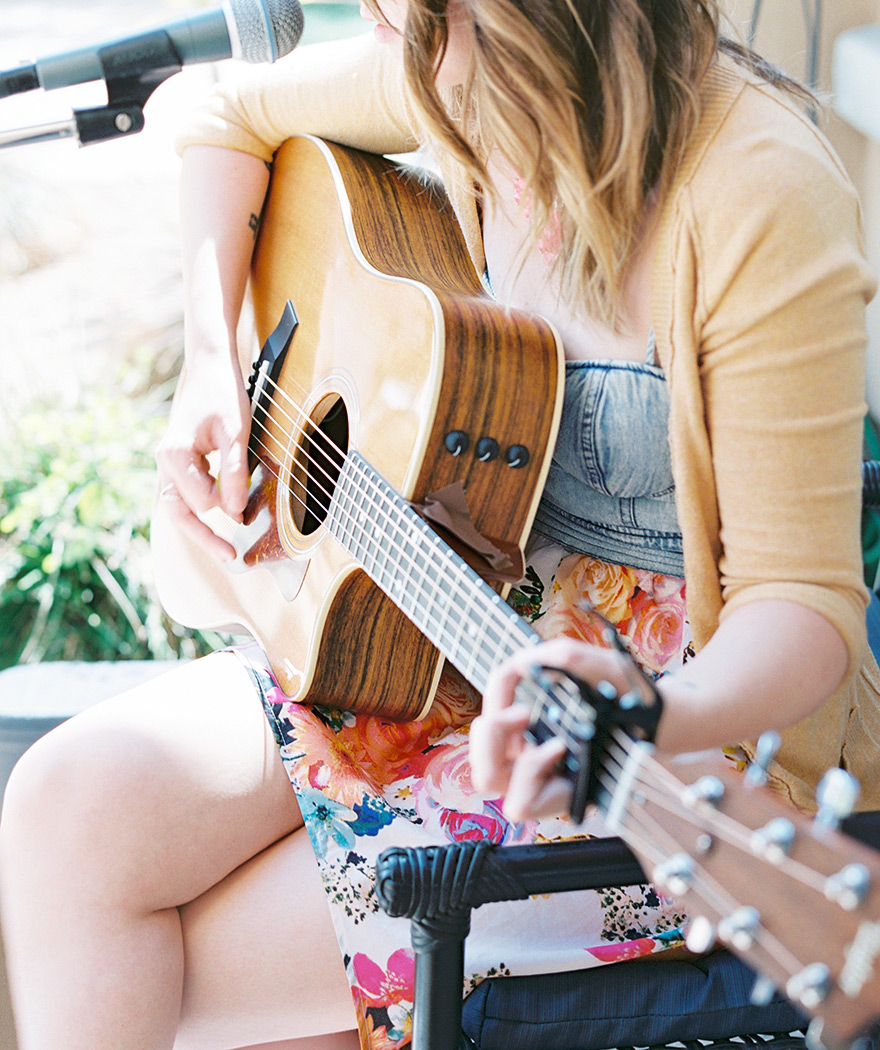 Female singer plays acoustic guitar