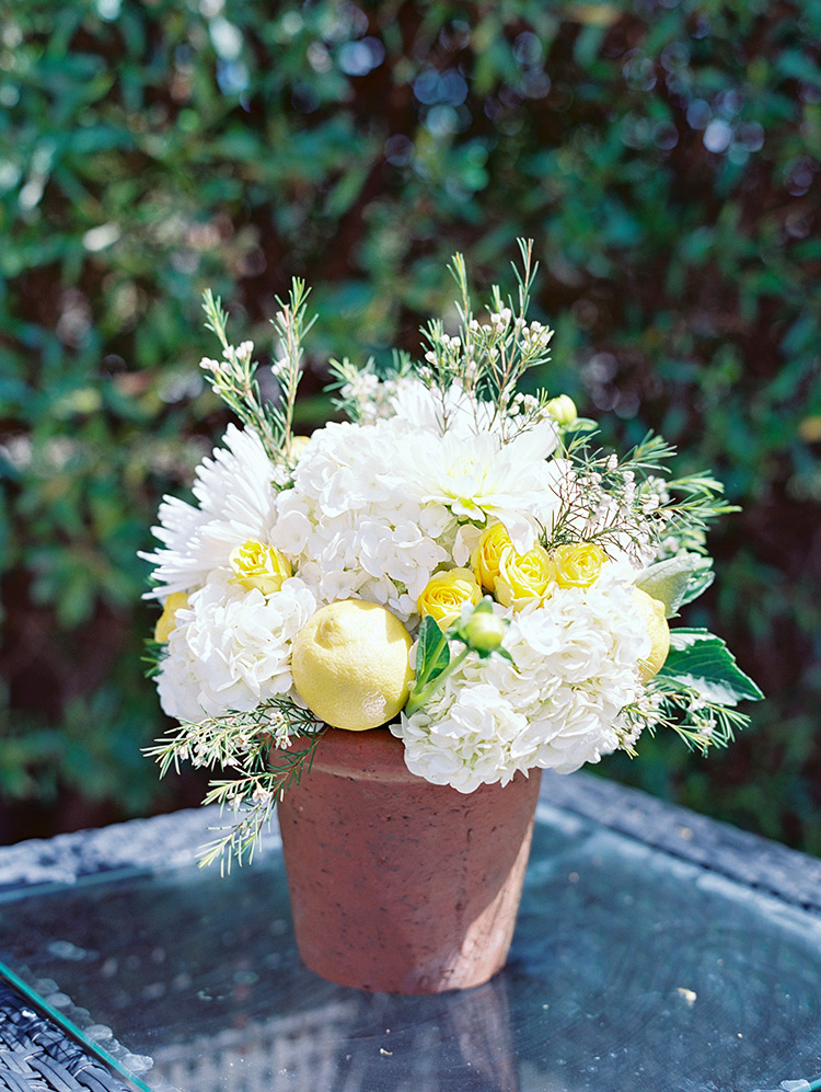 Centerpiece of white flowers studded with lemons