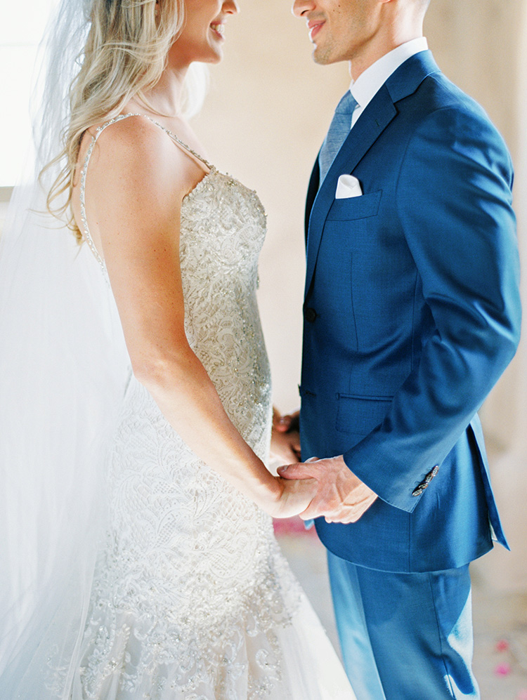 lace & tulle wedding gown for the bride, blue suit for the groom