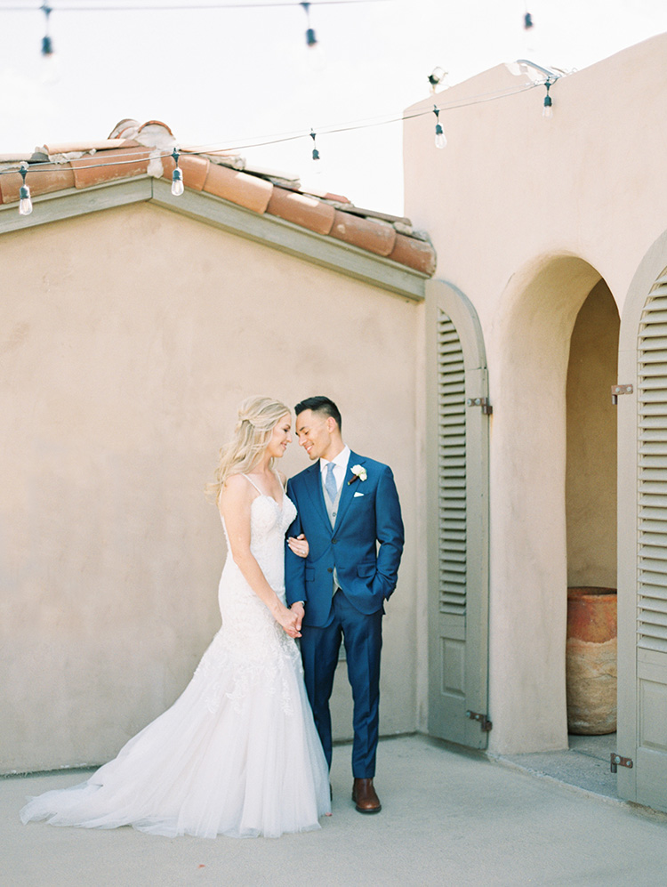 lace & tulle wedding gown for the bride, blue suit for the groom