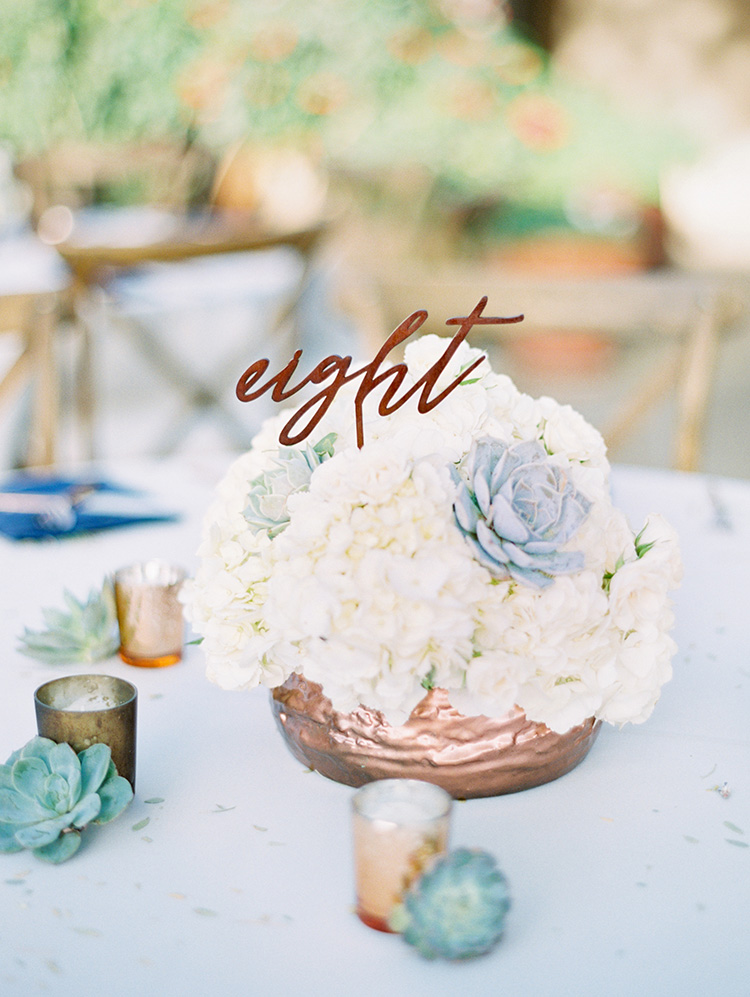 white flowers and succulents with metallic accents