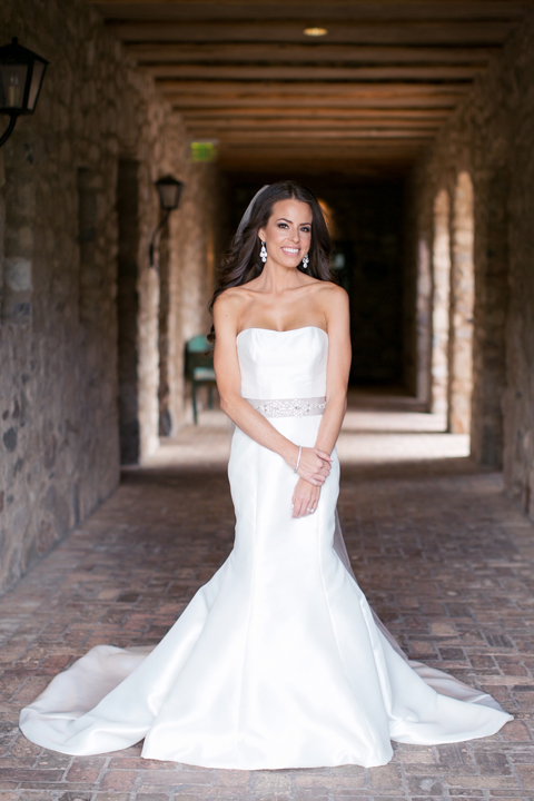 Full length bridal portrait of a bride with loose hair and a strapless fit-and-flare gown