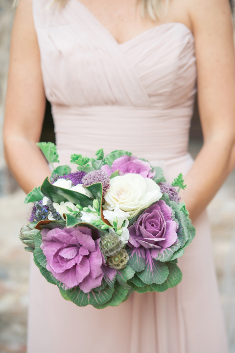 Bridesmaid in a draped blush gown. Vegetable bouquet with kale, roses, magnolia leaves.