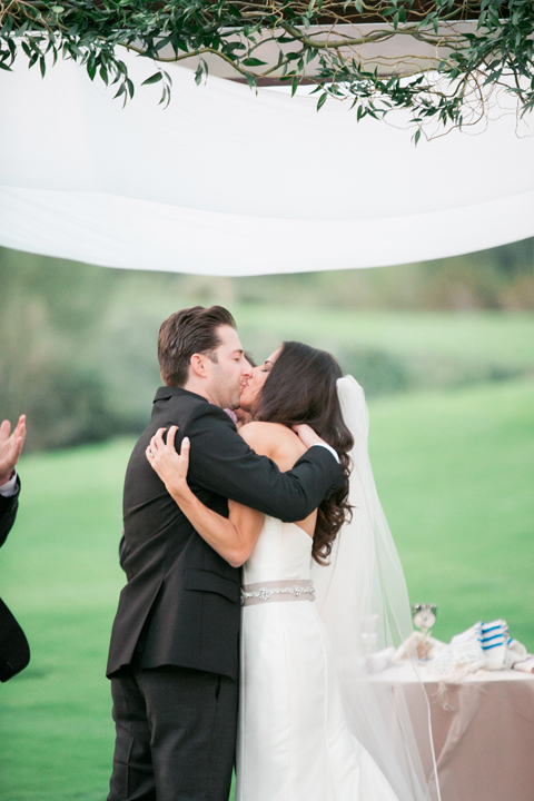 First kiss as man and wife. Outdoor wedding ceremony