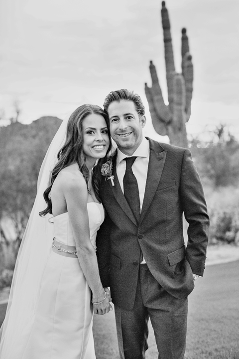 Black & white portrait of a happy bride and groom with cactus in the background. Arizona wedding.