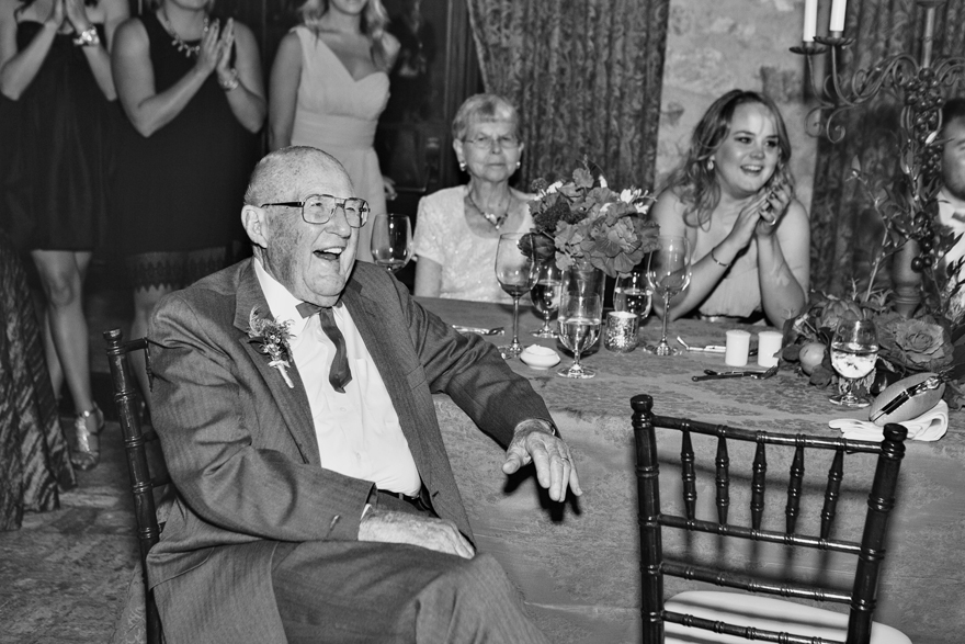 Wedding guests laugh at the toasts during an elegant wedding reception