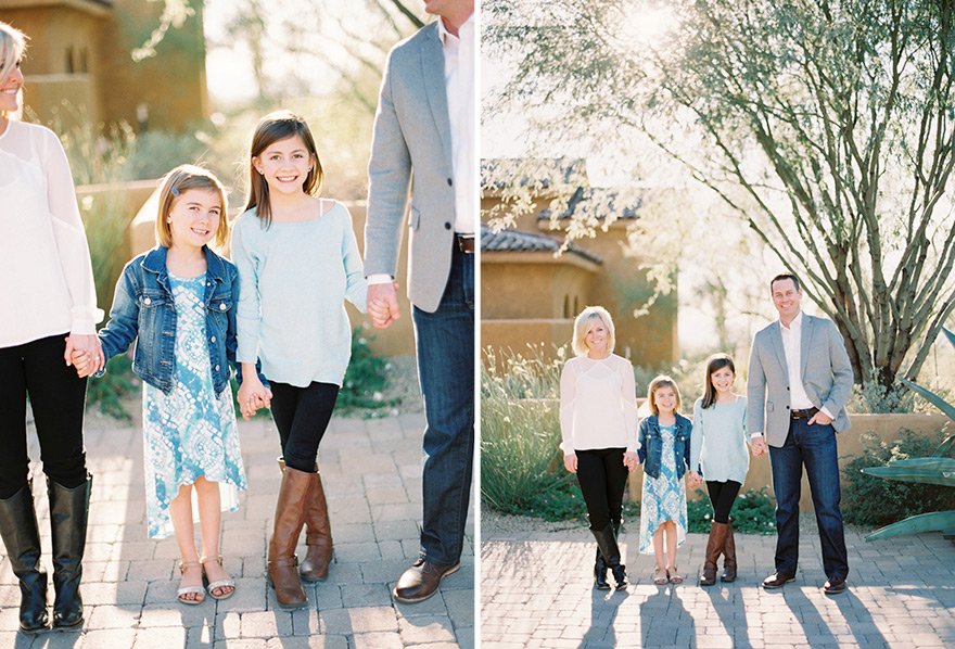 Adorable two daughters holding parents hands in a family session