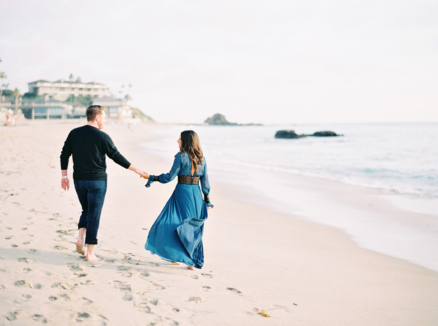 holding hands and walking on the beach