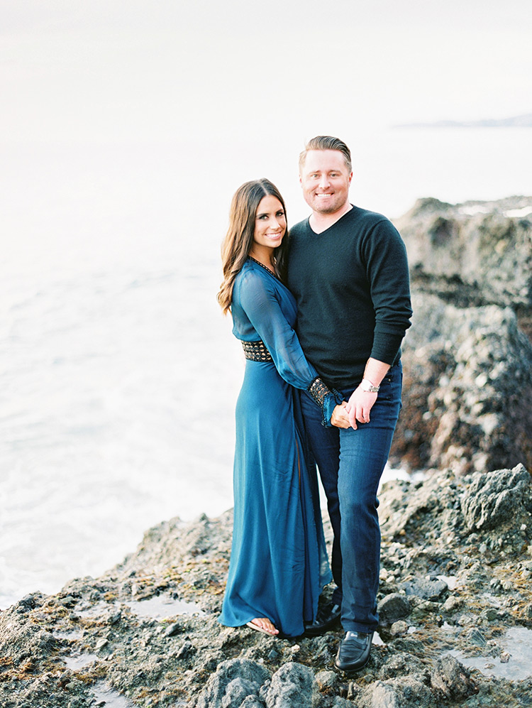 on the craggy rocks at Victoria Beach, engagement photos