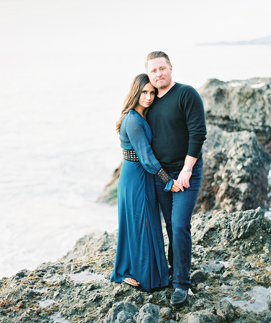 on the craggy rocks at Victoria Beach, engagement photos