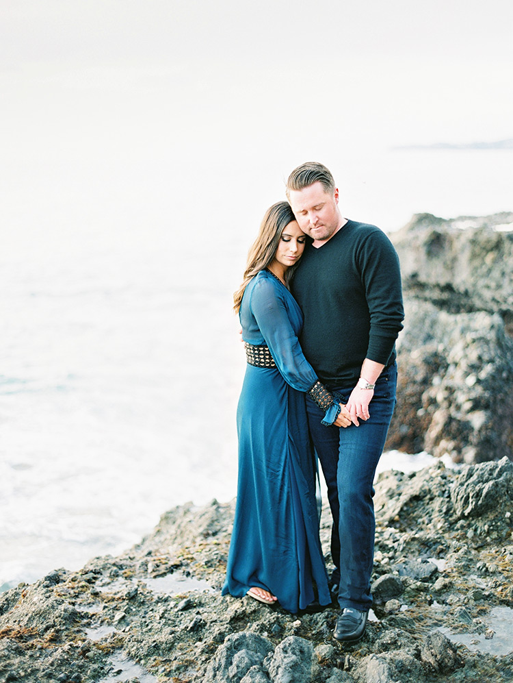 on the craggy rocks at Victoria Beach, engagement photos