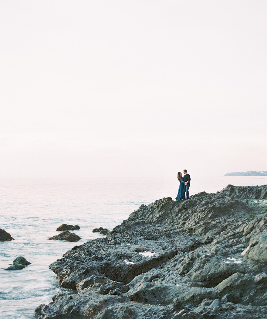 on the craggy rocks near La Tour at Victoria Beach, engagement photos