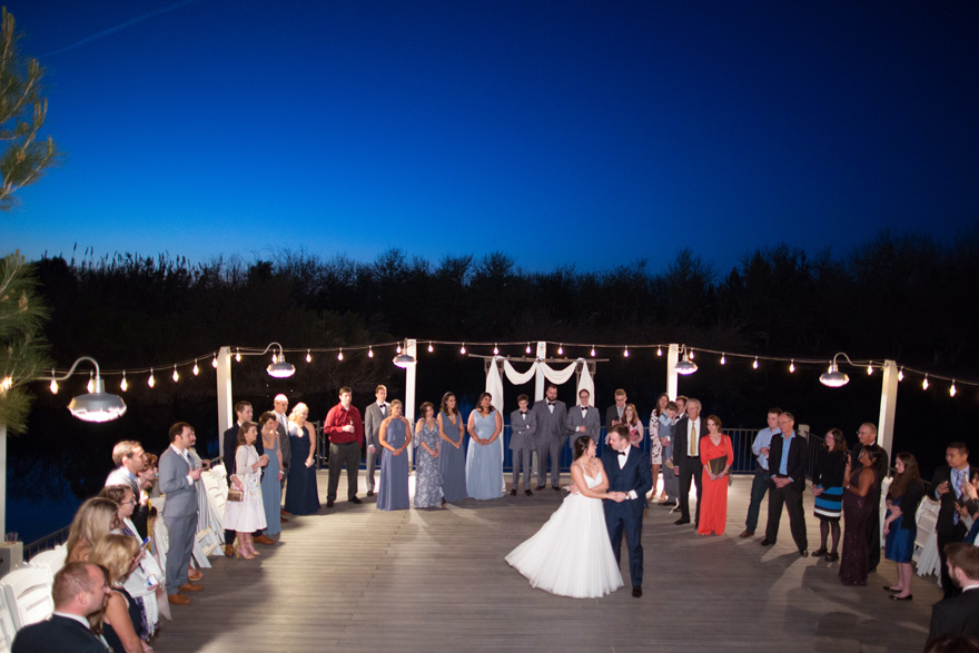 First dance as husband and wife on the lakeside dock