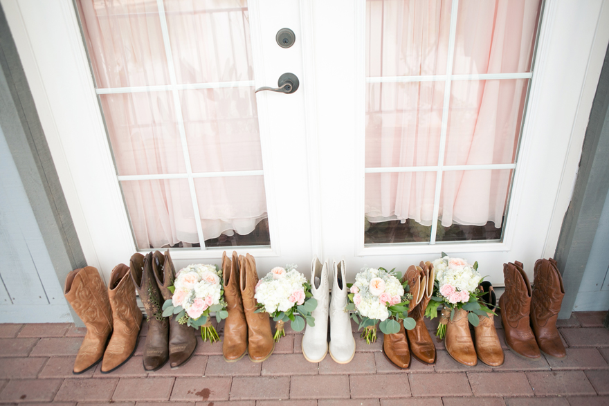 Country wedding cowboy boots for bridal party with bouquets. Wedding inspiration and ideas.