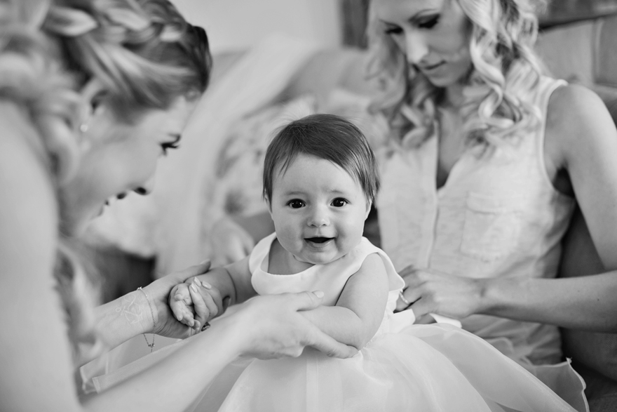 Beautiful baby girl getting dressed up for her parent's wedding day. Wedding inspiration and ideas.
