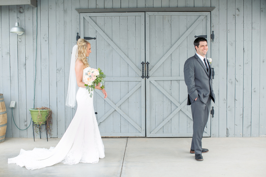 Bride and groom first look on their wedding day. Blonde bride wearing lace a-line dress.