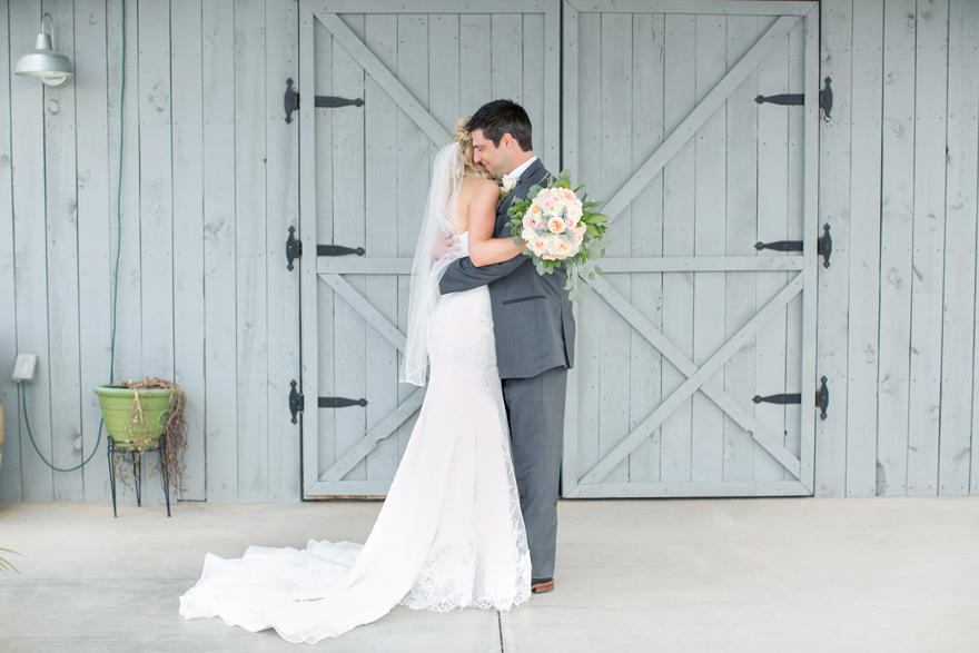 Bride and groom first look on their wedding day. Blonde bride wearing lace a-line dress.