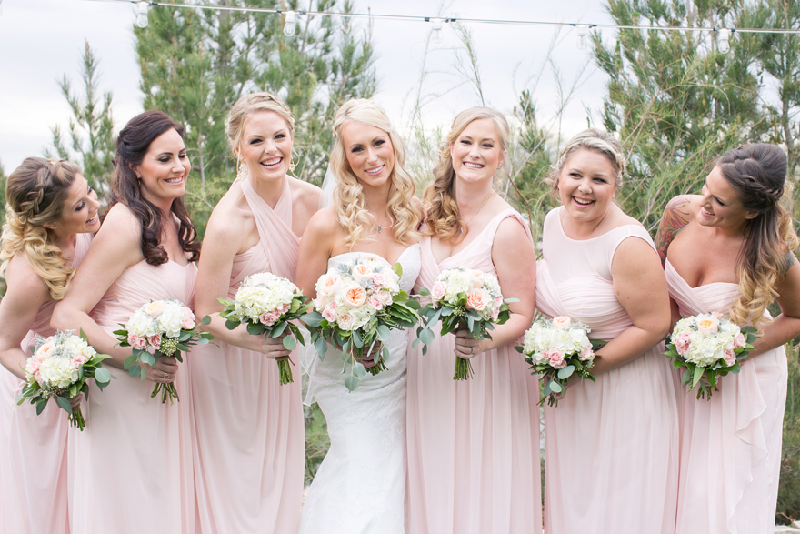 Bride and her bridal party on her wedding day. Light & pastel pink bridesmaids dresses.