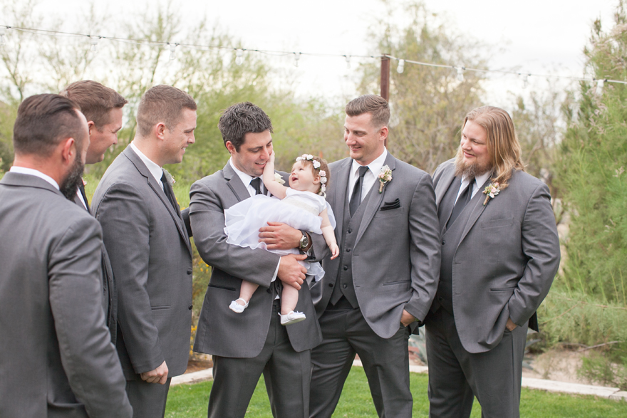 Groom with his baby daughter during the groomsmen portrait session.