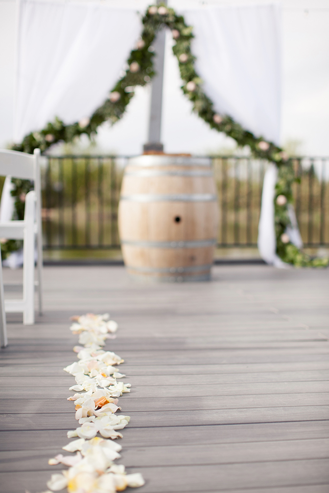 Flower petals down the isle at country inspired wedding. Wedding decor inspiration and ideas.