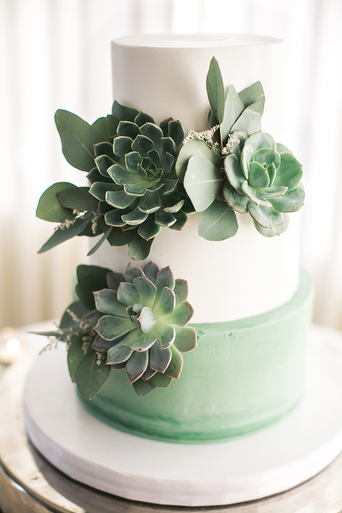 green & white wedding cake with succulents